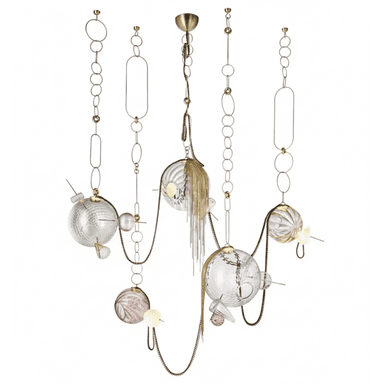 A striking multi-tiered chandelier featuring an intricate arrangement of brass-toned metalwork, decorative chains, and a variety of clear and pink glass spheres. Some glass elements are smooth, while others exhibit fluted or textured surfaces. The design includes cascading metal tassels and small, integrated light sources within or alongside the glass components, creating a luxurious and artistic statement piece. — 3D model (AI enhanced source)