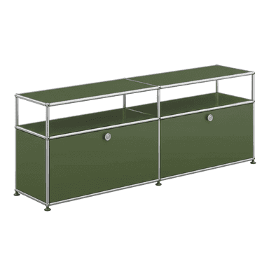 A modular cabinet unit with a metal frame and green cabinet fronts and top surface. It features two large drawers or cabinet doors on the lower level, each with a silver circular handle. The upper level is open shelving. The unit is supported by small, round feet. — 3D model (AI enhanced source)