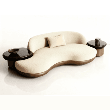 An organically shaped, cream-colored upholstered sofa featuring a sinuous, low-profile design. It is supported by a subtly visible wooden base and includes two integrated, round side tables with dark, possibly black marble tops, positioned at each end of the seating unit. A small, light-colored toss pillow rests on the main seating surface. — 3D model (AI enhanced source)