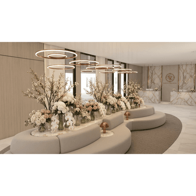 A large, modular, curved banquette sofa upholstered in a light beige textured fabric, featuring a multi-tiered design. The lower tier forms the main seating, while a higher, inner tier integrates a curved marble-topped surface used as a planter or display area, adorned with floral arrangements. The entire unit follows a sweeping, organic curve, designed for public or commercial spaces. — 3D model (AI enhanced source)