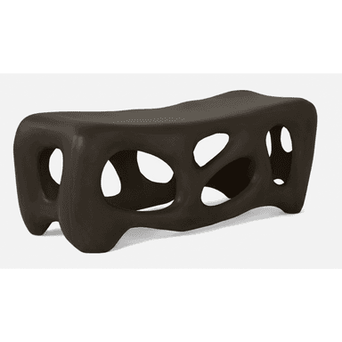 A modern, abstract bench with a dark brown, matte finish. The design features organic, irregular openings throughout its structure, creating a porous or skeletal appearance. Its form is elongated and somewhat fluid, with rounded edges and a low profile, resting on integrated leg-like supports that are part of the overall molded form. — 3D model (AI enhanced source)