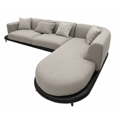 An L-shaped contemporary sectional sofa featuring light greige fabric upholstery, a distinctive rounded chaise component, and a low-profile black leather-wrapped base with slim black legs. The sofa includes multiple loose back cushions and several patterned throw pillows. — 3D model (AI enhanced source)