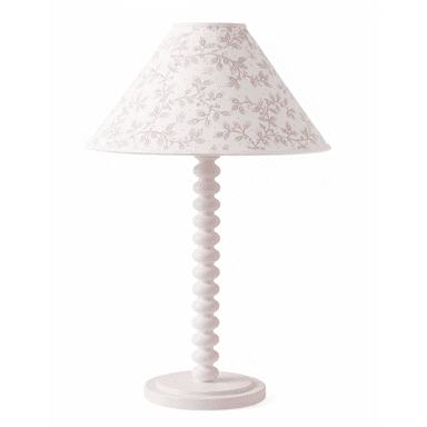 A charming table lamp featuring a solid pink bobbin-turned stem and a circular base. It is topped with a tapered drum lampshade adorned with a delicate floral and leaf pattern in pastel pink and green hues on a white background. The overall aesthetic is whimsical and soft. — 3D model (AI enhanced source)