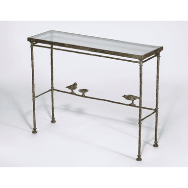A slender console table with a glass top and a decorative metal base. The base is designed to resemble a branch, featuring two small bird figures and a small dish attached to a lower horizontal support. The legs are thin and textured. — 3D model (AI enhanced source)