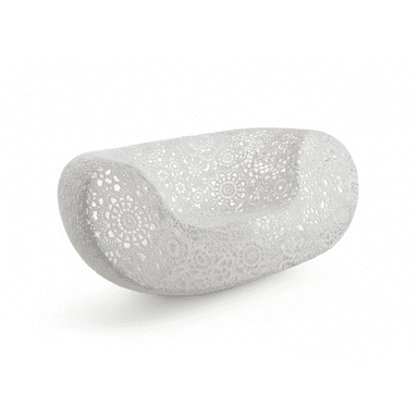 A modern, sculptural chaise lounge featuring an intricate, openwork crochet or lace-like pattern across its entire surface. The piece is curved and elongated, designed for comfortable reclining, and appears to be made from a light-colored, possibly synthetic resin material. — 3D model (AI enhanced source)