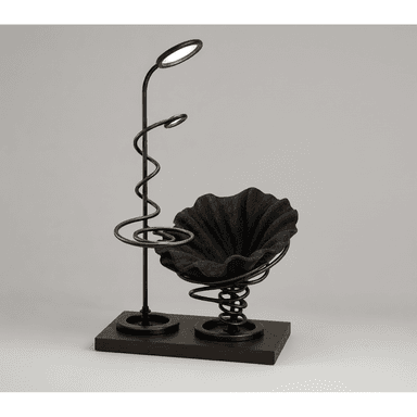 A modern accent chair featuring a dark, ruffled fabric seat supported by a prominent coiled spring mechanism. The chair is integrated with a floor lamp that has two oval LED light fixtures and a decorative spiral metal accent on its stand. Both the chair and the lamp are mounted on a dark wood base. — 3D model (AI enhanced source)