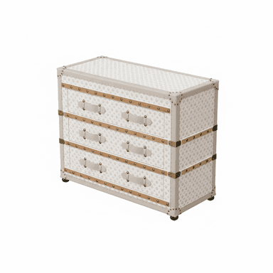 A chest of drawers designed to resemble a vintage travel trunk. It features three drawers, each with leather-like pull handles and decorative brass-colored hardware. The exterior is covered in a light-colored material with a repeating pattern, accented with beige trim and metal corner protectors. The piece is elevated by small black wheels at the base, suggesting mobility. — 3D model (AI enhanced source)