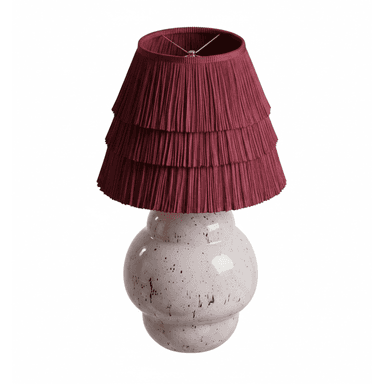 A table lamp featuring a rounded, bulbous ceramic base with a speckled finish and a tiered, pleated fabric shade. The base is a light, glossy hue with dark speckles, while the shade is a deep maroon or burgundy color, composed of several pleated fabric tiers that create a ruffled effect. — 3D model (AI enhanced source)