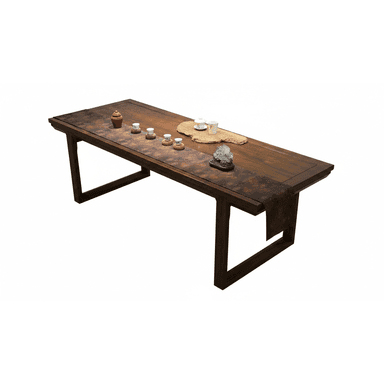 A dark brown rectangular solid wood table, likely used for dining or tea ceremonies. It features a thick, substantial tabletop with a rich, dark stained finish that reveals the natural wood grain. The table stands on two inverted U-shaped or Z-shaped legs, providing a stable and visually minimalist base. A patterned fabric runner with a traditional design is draped across the tabletop, adorned with a selection of tea ware and decorative items. — 3D model (AI enhanced source)
