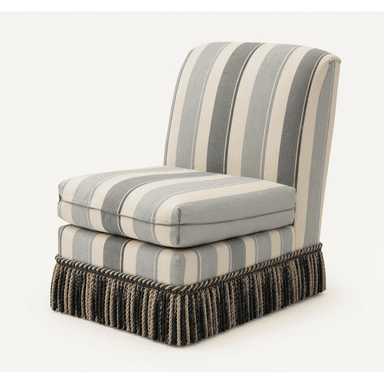 An armless slipper chair, fully upholstered in a vertically striped fabric featuring various shades of grey and cream. It features a loose, box-style seat cushion and a decorative tasseled fringe skirt at the base, concealing its legs. — 3D model (AI enhanced source)