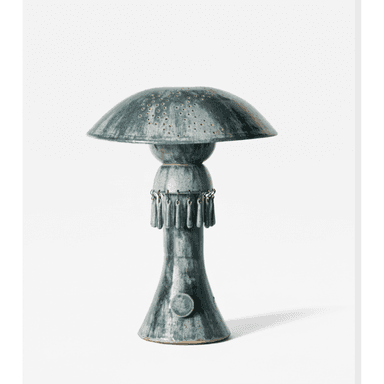 A ceramic table lamp featuring a distinctive mushroom-shaped shade with an array of small perforations. The lamp exhibits a rich, mottled blue-green glaze. Below the shade, a decorative band supports multiple hanging ceramic elements, creating a fringe-like detail. The base is conical, flaring slightly towards the bottom. — 3D model (AI enhanced source)