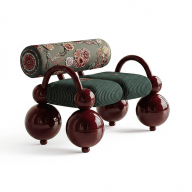 A whimsical sculptural two-seater bench featuring a glossy burgundy lacquered frame and legs, contrasted with distinct upholstered cushions. The frame is constructed from large spherical elements that form the legs and smaller spheres for feet, connected by smooth, curved supports. The two seat cushions are upholstered in a dark green fabric with a subtle texture, while the cylindrical back bolster is covered in a lighter sage-green fabric adorned with intricate, multi-colored floral and medallion embroidery. — 3D model (AI enhanced source)