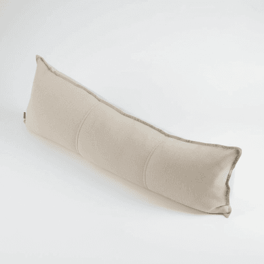 A long, rectangular bolster pillow made from a light beige woven fabric, featuring piped edges and subtle segmentation stitches across its body. The pillow is shown against a plain white background. — 3D model (AI enhanced source)