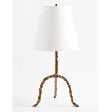 A table lamp featuring an organic, textured tripod base with a matte gold finish, topped by a simple white tapered drum shade. The base branches from a central column into three splayed, irregular legs, giving it a natural, rustic yet contemporary appearance. — 3D model (AI enhanced source)
