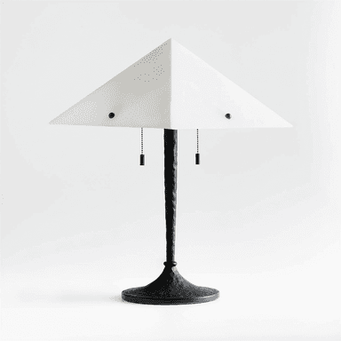 This is a contemporary table lamp featuring a distinctive pyramidal, frosted acrylic shade. The shade is held by two black finials and illuminates downwards. The lamp's stem is dark, possibly black metal, with a textured, almost twisted appearance, tapering upwards from a substantial, hammered-texture round base. It includes two black pull chains for operation, suggesting individual bulb control. — 3D model (AI enhanced source)