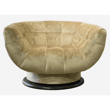 A plush, round tufted lounge chair with a swivel base, upholstered in a golden-beige velvet or chenille fabric. The chair features deep channel tufting across its entire body, creating a soft, inviting aesthetic. It rests on a visible, dark circular wooden or composite swivel base, suggesting a mid-century modern influence. — 3D model (AI enhanced source)