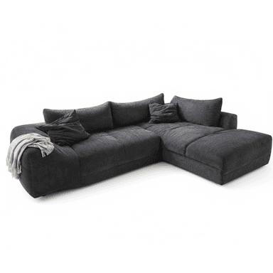 A large, dark gray L-shaped sectional sofa upholstered in a textured fabric, possibly corduroy or chenille. It features multiple plush seat and back cushions, including a prominent chaise lounge section on the right side. Several matching throw pillows and a draped light-colored blanket complete the casual, contemporary look. The sofa has a low-profile design and substantial, inviting seating. — 3D model (AI enhanced source)