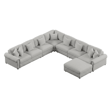 A large, light gray sectional sofa with a U-shaped configuration and an attached ottoman. The sofa features multiple seating modules, plush cushions, and decorative nailhead trim along the base. It includes several throw pillows for added comfort and style. — 3D model (AI enhanced source)