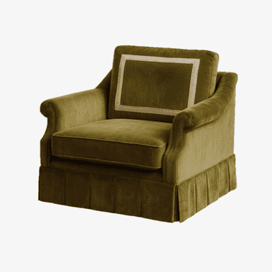 An upholstered armchair in a deep olive green velvet fabric, featuring rolled arms, a loose seat cushion, and a loose back cushion. The back cushion is adorned with a decorative square banding in a lighter tone. The armchair sits on a pleated skirt base. — 3D model (AI enhanced source)