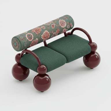 A distinctively designed two-seater loveseat, featuring a postmodern aesthetic. It comprises two rectangular seat cushions upholstered in an emerald green fabric with a subtle dotted texture. The supporting frame and legs are crafted from glossy, deep burgundy lacquered elements, including prominent spherical feet and curved tubular arms that extend to support a cylindrical bolster backrest. The bolster is upholstered in a rich, multi-colored floral pattern displaying hues of pink, red, blue, and green against a muted green ground. — 3D model (AI enhanced source)