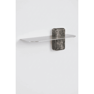 A modern wall shelf with a minimalist design. The shelf is a flat, elongated rectangular plane with rounded edges, made of a metallic material. It is supported by a vertical element attached to the wall, which is partially visible. A decorative block, possibly made of stone with a marbled pattern, sits on the shelf, partially obscuring the support. The overall aesthetic suggests contemporary or abstract design. — 3D model (AI enhanced source)