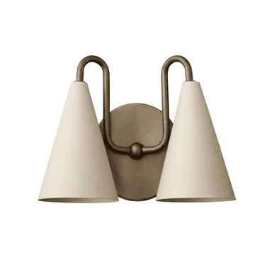 A two-light wall sconce featuring an antique brass finish metal frame and two conical shades. The fixture mounts to the wall via a circular backplate, from which two U-shaped arms extend upwards and curve down to hold the individual lamp shades. The shades are off-white, likely fabric, with a distinct conical shape. — 3D model (AI enhanced source)