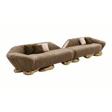 A contemporary modular sectional sofa composed of two distinct sections, upholstered in a ribbed, taupe-brown velvet-like fabric. The sofa features a low-slung profile with gently curved backrests and arms. Its most distinctive feature is the series of organic, sculptural gold-toned bases that support each section, resembling molten metal or polished stone. Each section includes scatter cushions in contrasting green and cream colors. — 3D model (AI enhanced source)