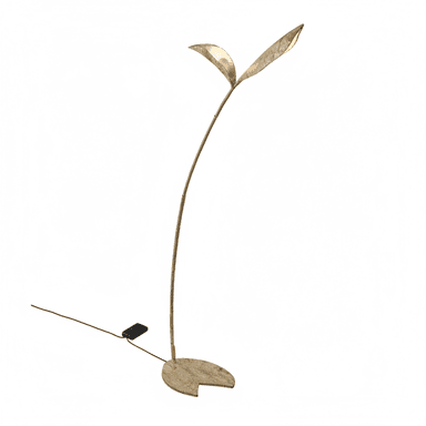 A tall, slender floor lamp with an organic, botanical design, featuring a distressed gold or bronze finish. The lamp has a round, flat base from which a curved stem extends upwards, culminating in two leaf-shaped elements that house the light sources. A black power cord with an inline foot switch extends from the base. — 3D model (AI enhanced source)