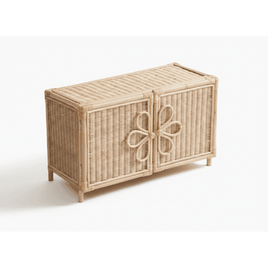A small, rectangular accent cabinet constructed from woven natural rattan, featuring two front-opening doors. Each door is adorned with a stylized floral or bow-like motif made from bent rattan, which also functions as a handle. The cabinet stands on four short, rounded legs, and the top and side panels are also woven. — 3D model (AI enhanced source)