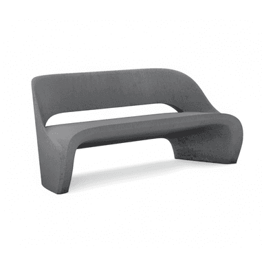 A modern, dark gray, monolithic bench made of concrete, featuring a continuous, curved form that integrates the backrest, seat, and base. It has an open-back design with a distinct gap between the seat and back, contributing to its sculptural aesthetic. — 3D model (AI enhanced source)