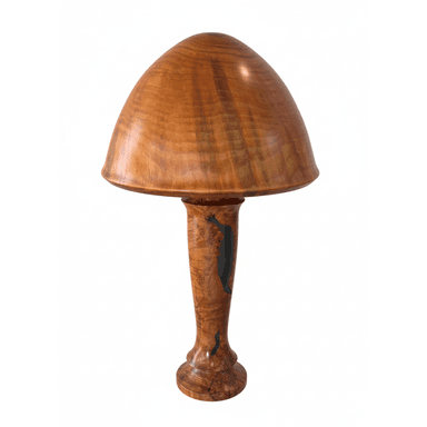 A distinctive mushroom-shaped table lamp crafted from highly figured wood, featuring a smooth, domed cap and a tapering cylindrical stem with a flared base. The stem includes irregular, darker, possibly epoxy-filled voids or inlays, adding a unique organic detail to the design. — 3D model (AI enhanced source)