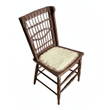 A dark wood and wicker side chair with an upholstered seat. The chair features a high backrest with an intricate woven wicker pattern, resembling spindles, and turned wooden legs with stretchers. The seat is a padded cushion covered in a light-colored, subtly patterned fabric with decorative trim. — 3D model (AI enhanced source)