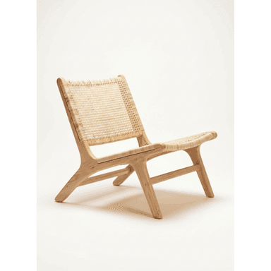 A low-slung lounge chair featuring a natural light-toned wooden frame and woven cane seat and backrest. The frame has a minimalist, sculpted design with gently curved lines, providing a relaxed recline. The open weave of the cane adds textural interest and promotes breathability. — 3D model (AI enhanced source)