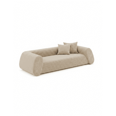 A long, low-profile sofa with rounded edges, upholstered in a light beige, textured fabric, accompanied by two matching throw pillows. Its design features integrated, gently curved armrests and backrest, creating a continuous, minimalist form that extends to the floor. — 3D model (AI enhanced source)