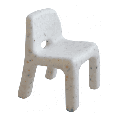 A small, monolithic children's chair made from recycled white plastic with multi-colored flecks. It features a low backrest with a cutout and thick, integrated legs, designed for stability and durability. — 3D model (AI enhanced source)