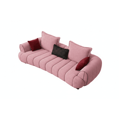 A modern, curved, pink upholstered sofa, featuring distinctive channel tufting on the seat and back. It includes three loose back cushions and is accessorized with two dark red and one black textured throw pillows. The sofa has a low profile with integrated armrests that curve gently upwards, outlined with dark piping. — 3D model (AI enhanced source)