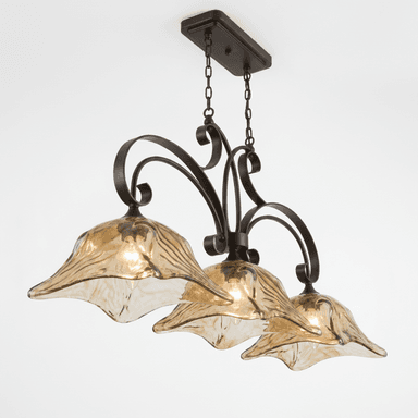 A multi-light chandelier featuring a dark bronze-finished metal frame with ornate scrollwork arms. It is suspended by chains from a rectangular ceiling canopy. The chandelier supports three bell-shaped light shades made of amber-colored art glass with a fluted or textured surface, designed to resemble flower petals. Each shade houses a single light bulb. — 3D model (AI enhanced source)