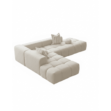 A modular sectional sofa with a low profile and generous depth. The sofa features a tufted, pixelated design on its seat and back cushions, creating a contemporary aesthetic. It is upholstered in a textured, boucle-like fabric. Two throw pillows, one rectangular with striped pattern and one round, are placed on the sofa. The sofa is configured in an L-shape. — 3D model (AI enhanced source)