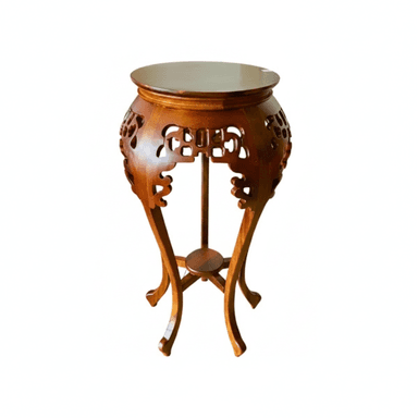 A round, carved wooden pedestal table featuring ornate East Asian-inspired openwork carvings on its apron and elegant S-curved legs. It has a single round top surface and a smaller lower shelf, all in a dark, warm brown finish. — 3D model (AI enhanced source)