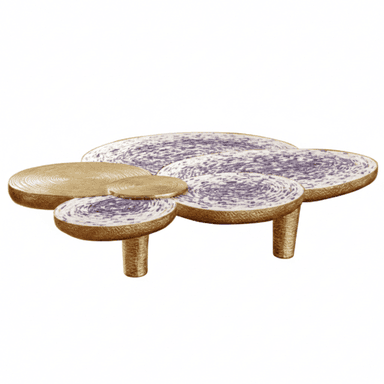 A sculptural table composed of multiple circular and oval-shaped platforms at varying elevations, designed to function as a coffee table or accent piece. Some surfaces feature a textured gold finish, while others exhibit a white base with intricate purple and white patterns, resembling woven or speckled material. The table is supported by short, cylindrical legs with a matching gold texture. — 3D model (AI enhanced source)