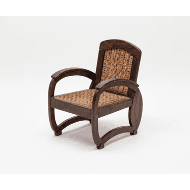 A dark-stained wooden armchair featuring a sturdy frame with curved armrests and legs, and intricately woven cane for both the seat and the backrest. The design suggests a classic, possibly colonial or tropical aesthetic. — 3D model (AI enhanced source)