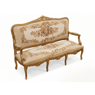 An ornate, antique-style settee in the Louis XV aesthetic, featuring an intricately carved giltwood frame and rich floral needlepoint upholstery. The frame showcases characteristic Rococo elements such as scrolling motifs, shell details, and acanthus leaves, all finished in a radiant gold. The backrest and seat are upholstered with a fine needlepoint fabric displaying a detailed floral pattern in various colors on a light, likely cream or beige, background. The armrests are partially upholstered, and the settee stands on elegant cabriole legs. — 3D model (AI enhanced source)
