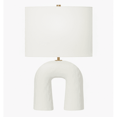 A modern table lamp featuring a distinctive arch-shaped ceramic base and a classic cylindrical fabric drum shade. — 3D model (AI enhanced source)