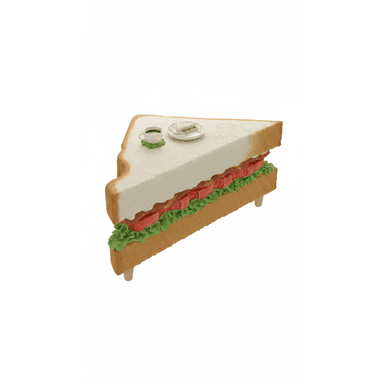 This image features a novel and whimsical accent table designed to resemble a large, diagonally-cut club sandwich. The table's surface is the 'top slice' of bread, with a visible crust edge. Below this, layers mimicking lettuce (green ruffled texture), tomato slices (red ovals), and bacon strips (brown textured elements) form the sides of the table. Four short, light-colored cylindrical legs support the structure from the bottom 'slice' of bread. A miniature coffee cup on a green coaster and a small plate with a tiny sandwich rest on the table's surface, indicating its scale and function. — 3D model (AI enhanced source)