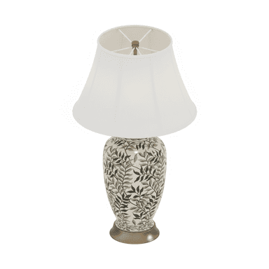 A decorative table lamp featuring an urn-shaped ceramic base adorned with a botanical leaf pattern in shades of gray and black. It sits on a gold-toned metal pedestal and is topped with a white tapered drum fabric shade. — 3D model (AI enhanced source)