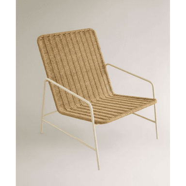 A lounge chair featuring a natural woven rattan seat and back, supported by a slender, light-colored metal frame with integrated armrests. The design is minimalist and contemporary. — 3D model (AI enhanced source)