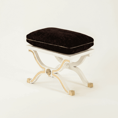 A white and gold X-base stool with a dark brown upholstered cushion, featuring classical design elements. — 3D model (AI enhanced source)