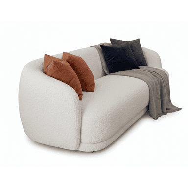 A contemporary, curved sofa upholstered in a textured cream-colored boucle fabric, featuring a smooth, organic silhouette without visible legs. The sofa includes several accent pillows in varying textures and colors, specifically two rust-colored boucle pillows, one dark blue velvet pillow, and one charcoal gray fabric pillow, along with a light grey herringbone throw blanket draped over its seat and backrest. — 3D model (AI enhanced source)