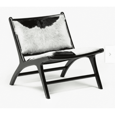 An armless lounge chair featuring a low-slung black wooden frame and upholstery made from genuine black and white cowhide. The chair has a minimalist design with a reclined backrest and a wide seat, supported by a sturdy, curved wooden frame. — 3D model (AI enhanced source)