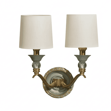 A traditional two-light wall sconce featuring a light green and gold ornate backplate, curved brass arms, crystal sphere accents, and tapered cream fabric shades. — 3D model (AI enhanced source)